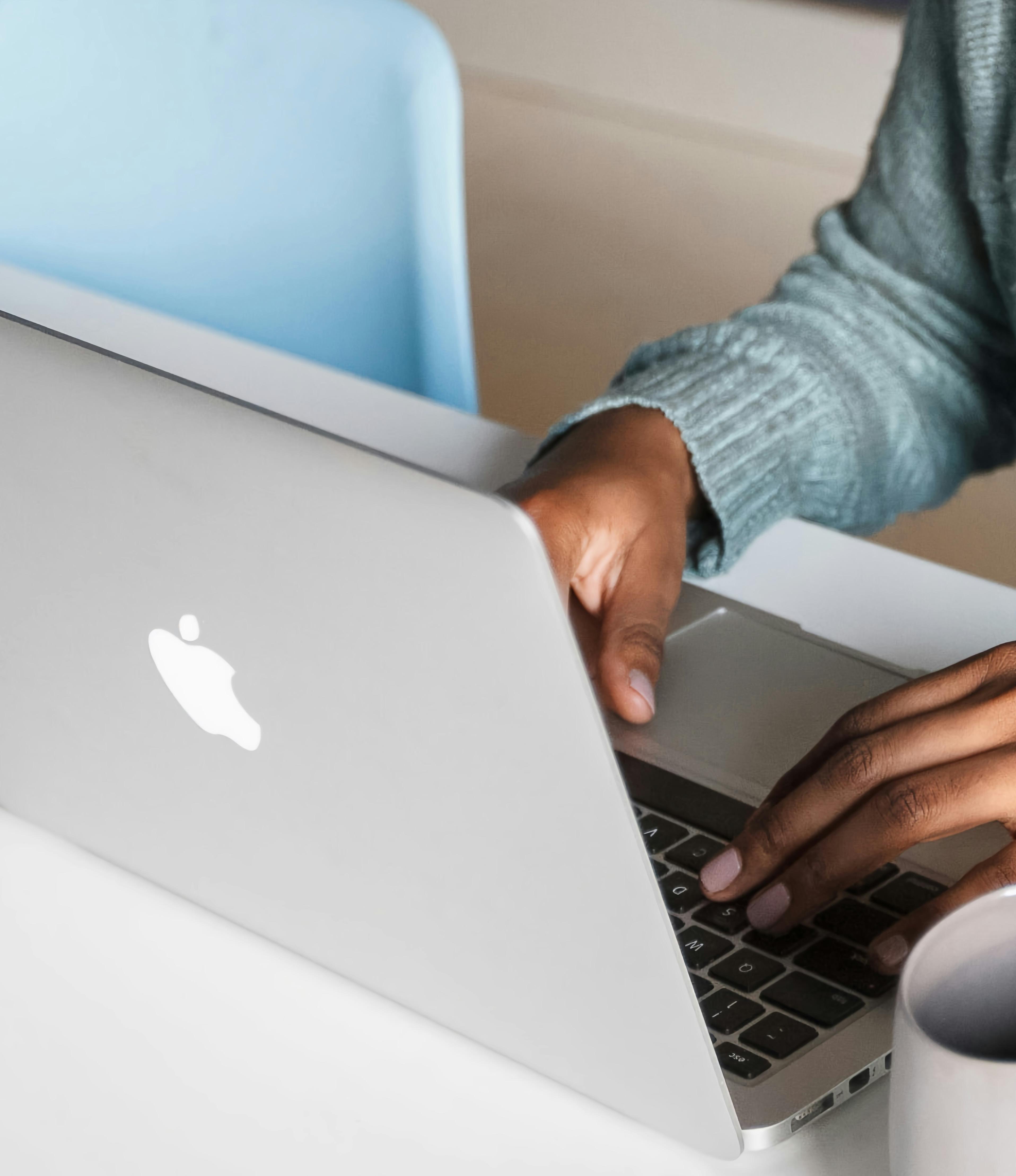 Photo of a woman typing on laptop computer